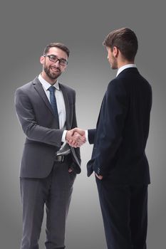 in full growth. business people shaking hands. isolated on white background