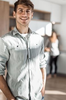 handsome young man standing in his kitchen. photo with copy space