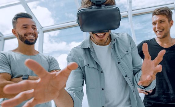 man using Virtual Reality and laughing with arms stretched