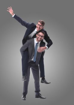 smiling businessman sitting on the back of his colleague . isolated on white background.