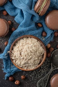 Chocolate macaroons with hazelnut flour on a blue textile