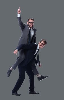 happy businessman carrying his colleague on the piggyback . isolated on white background