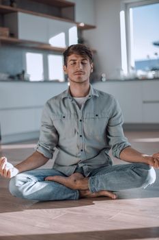 smiling young man standing in front of his colleagues. photo with copy space