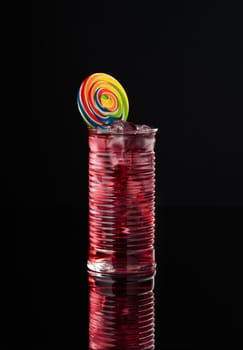 Cocktail in a glass on a black background vertical