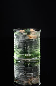 Cocktail in a glass on a black background vertical
