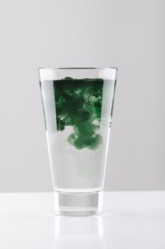 minimalist glass with water and spirulina powder. High quality photo