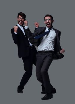 in full growth. two very happy young businessmen . isolated on white background.