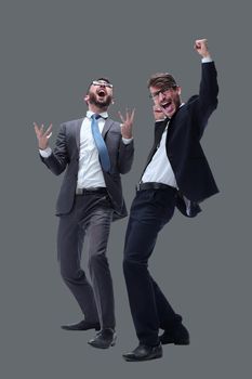 in full growth. two happy dancing young businessmen . isolated on white background.