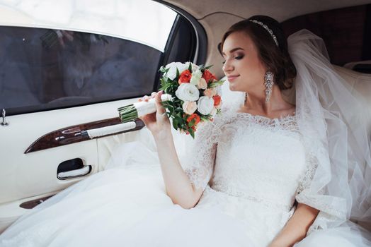 Portrait of a beautiful young bride in the car.