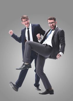 in full growth. two very happy young businessmen . isolated on white background.