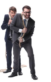 full length . two businessmen pulling a long rope. isolated on white background.
