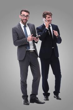 full length . two businessmen using their smartphones . isolated on white background