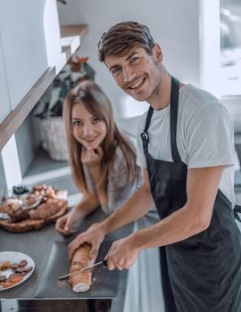 modern young couple having fun making sandwiches for Breakfast.