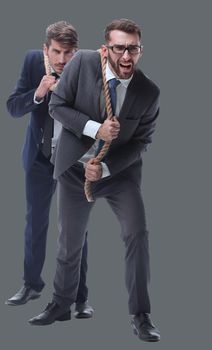 full length . two businessmen pulling a long rope. isolated on white background.