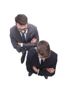 top view . two smiling businessmen looking at the camera . isolated on white background