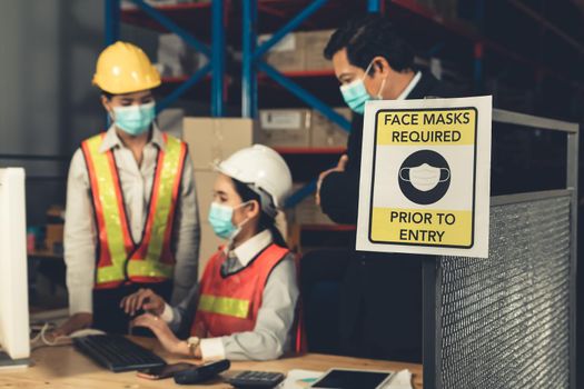 Caution sign in factory warning to industry labor worker to prevent Covid-19 Coronavirus spreading during job business reopening period after epidemic crisis . Working safely concept .