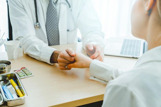 Doctor in professional uniform examining patient at hospital or medical clinic. Health care , medical and doctor staff service concept.
