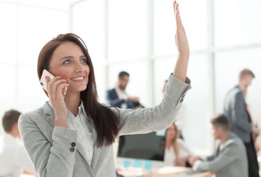 close up. young business woman talking on smartphone in office