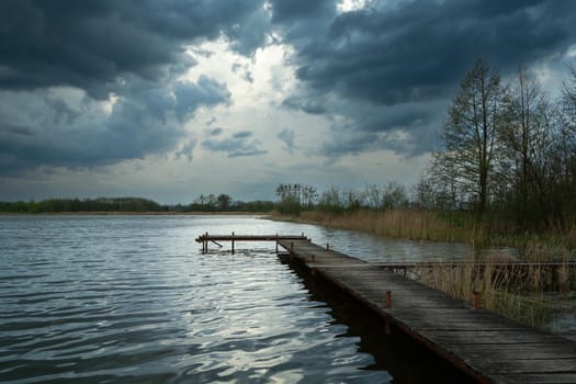 Wooden pier in a lake and cloudy sky, Stankow, Poland