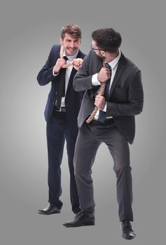 full length . two businessmen pulling a long rope. isolated on white background.