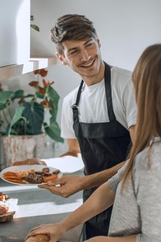 happy young couple standing in their new kitchen in the morning