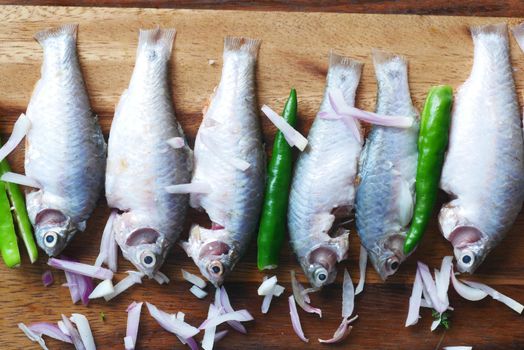 raw fresh sea fish on plate on table
