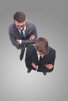 top view . two smiling businessmen looking at the camera . isolated on white background