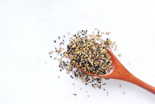 mixed of different spice on a spoon .