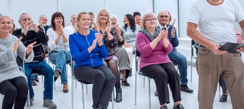 Smiling happy retirees studying in bussiness centre