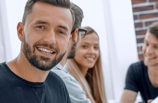 men is smiling during break, near modern office center. Young businessman lifestyle portrait. Technology and online communication concept