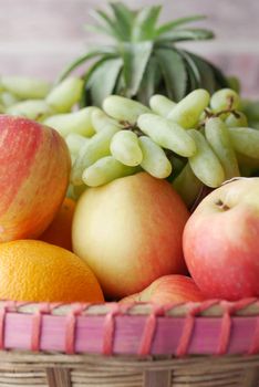 mixed fruits in a bowl on table .