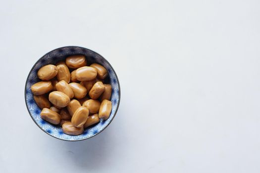 caramel chocolate bar in a bowl on white ,