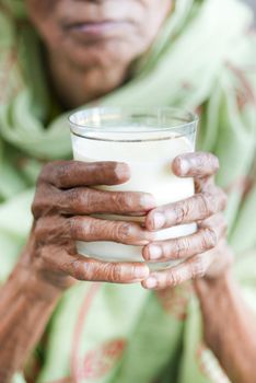 senior women hand holding a glass of milk ,