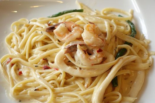 plate of sea food pasta on table .