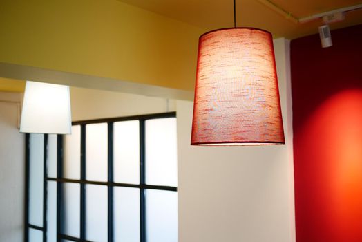 a lamp in a cafe against light green wall ,
