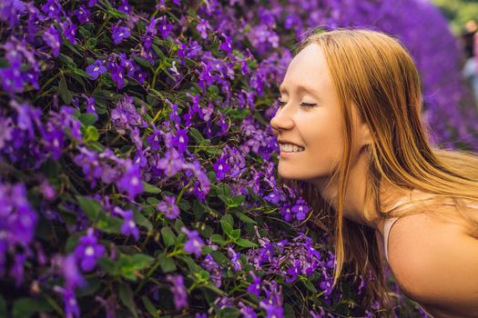 Young woman in a flower greenhouse. Bright tropical flowers..