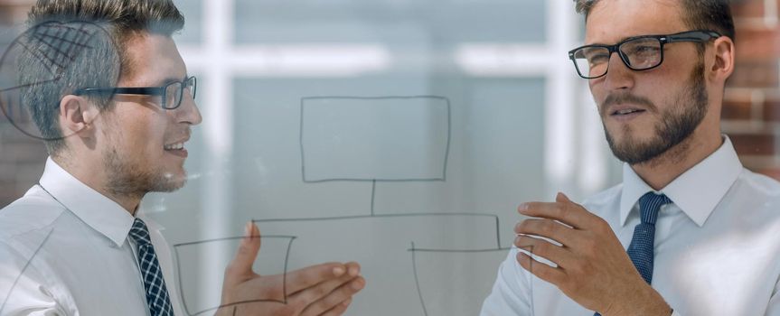 close up.two employees talking standing in the office.office weekdays