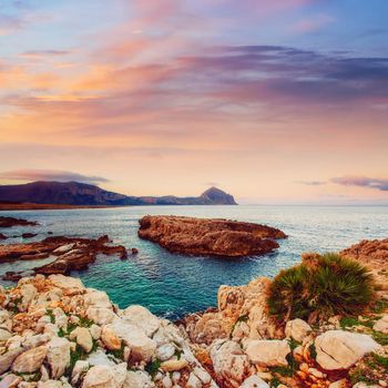 Fantastic view of the nature reserve Monte Cofano. Dramatic scene. Sunset over sea. Location cape San Vito. Sicilia, Italy, Europe. Mediterranean and Tyrrhenian sea.