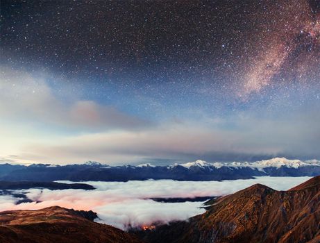 Starry sky above the thick fog on the mountain pass Goulet. Georgia, Svaneti. Europe. Caucasus Mountains