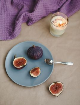 still life with ripe fresh figs and purple textiles on rustic background, flatlay, overhead view