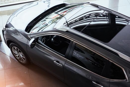of the car in the spacious showroom with large windows.