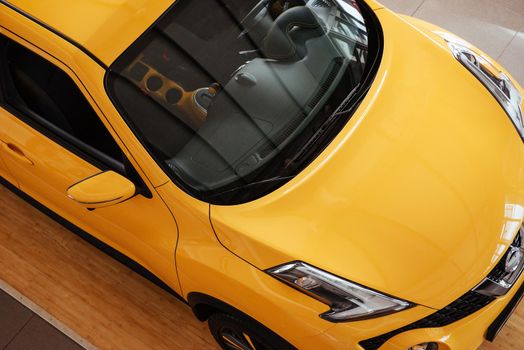 of the car in the spacious showroom with large windows.