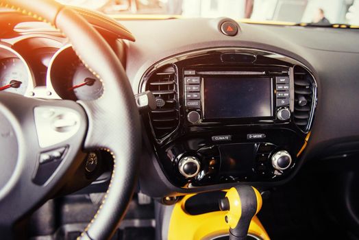 Modern car interior dashboard and steering wheel.