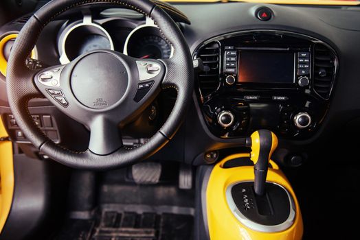 Modern car interior dashboard and steering wheel.
