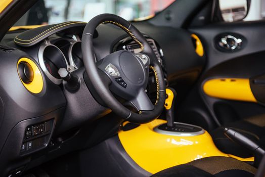Modern car interior dashboard and steering wheel.