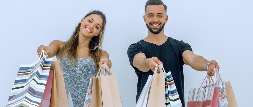 young couple shows shopping bags.isolated on white background