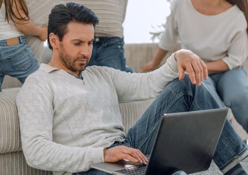 modern man working on a laptop in the living room.the concept of freelancing