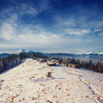 Cottage in snowy mountains with fabulous winter trees. Dramatic and picturesque scene. Carpathian. Ukraine, Europe.