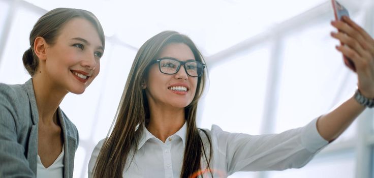 two employees taking a selfie in the workplace.photo with text space