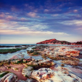 Fantastic view of the nature reserve Monte Cofano. Dramatic scene. Sunset over sea. Location cape San Vito. Sicilia, Italy, Europe. Mediterranean and Tyrrhenian sea.